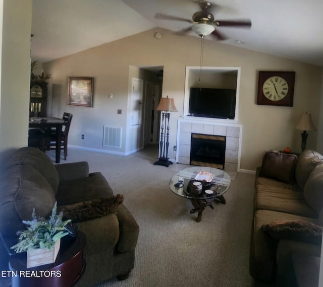 carpeted living room featuring ceiling fan, a fireplace, and vaulted ceiling