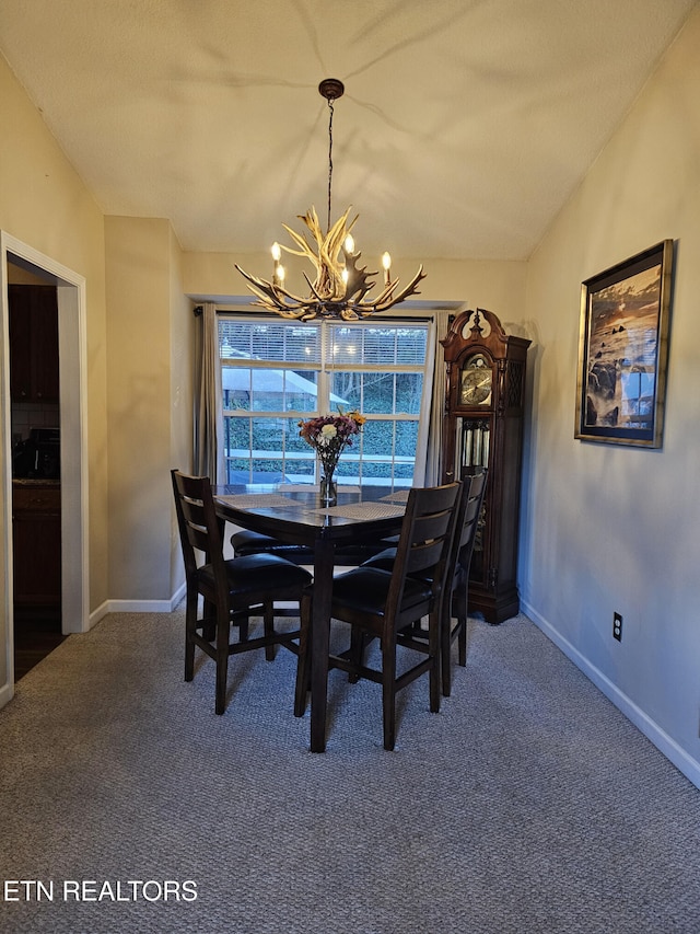 dining room featuring an inviting chandelier and carpet floors