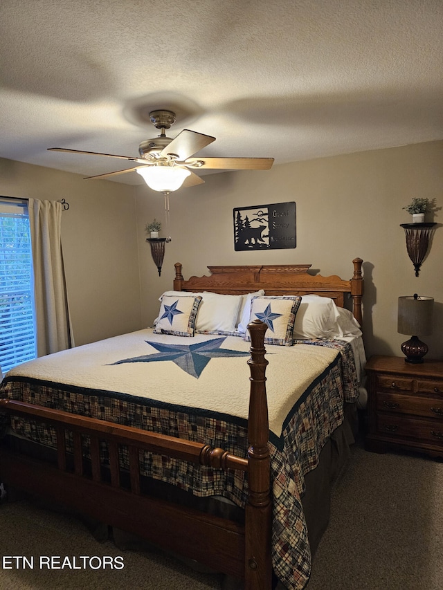 carpeted bedroom featuring a textured ceiling and ceiling fan