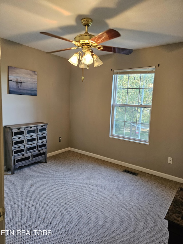 spare room featuring carpet flooring and ceiling fan