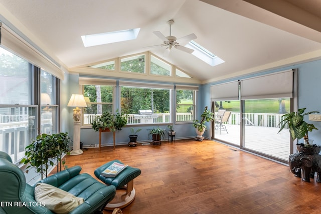 sunroom / solarium featuring lofted ceiling, plenty of natural light, and ceiling fan