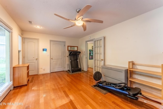 workout room featuring wood-type flooring and ceiling fan