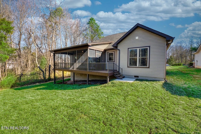 back of property featuring a lawn and a sunroom