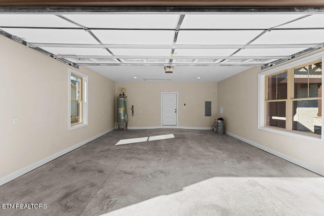 garage with a garage door opener, electric panel, and water heater