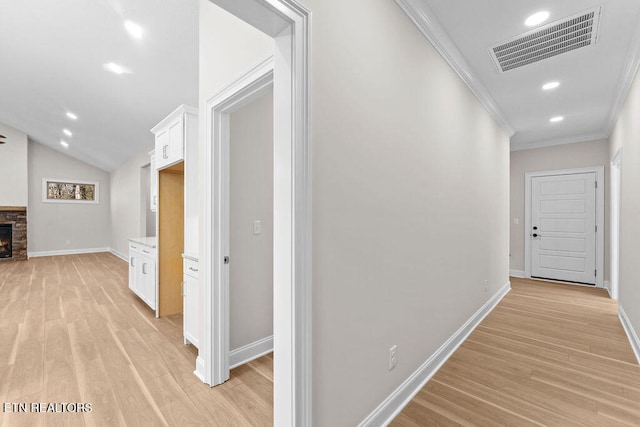 hallway featuring crown molding and light hardwood / wood-style floors