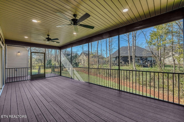 unfurnished sunroom with wood ceiling, ceiling fan, and a healthy amount of sunlight