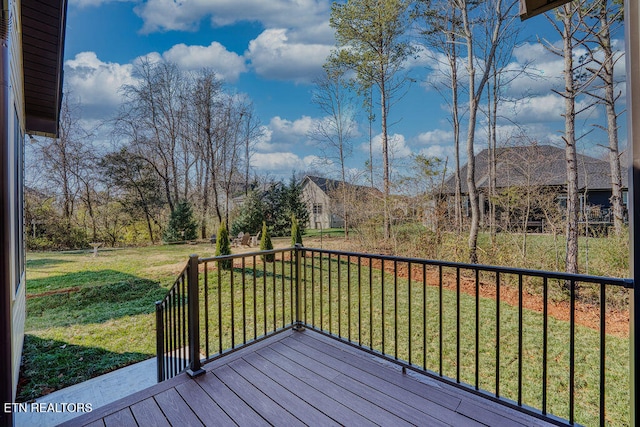 wooden terrace featuring a yard