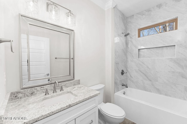 full bathroom featuring vanity, tiled shower / bath combo, and toilet