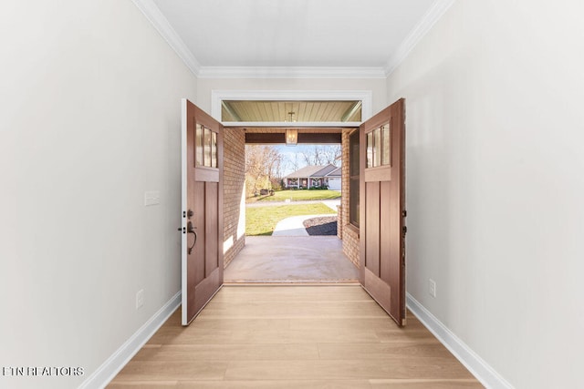 doorway featuring crown molding and light hardwood / wood-style flooring