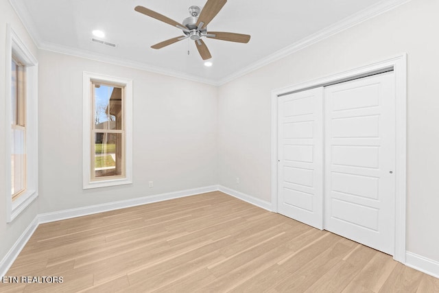 unfurnished bedroom with light hardwood / wood-style floors, a closet, ornamental molding, and ceiling fan