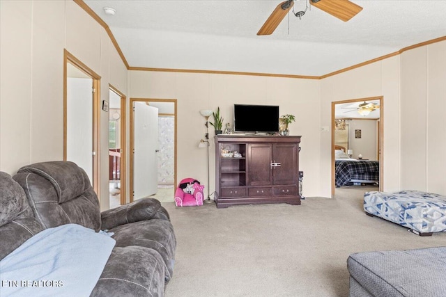 living room featuring ornamental molding, carpet, a textured ceiling, and ceiling fan