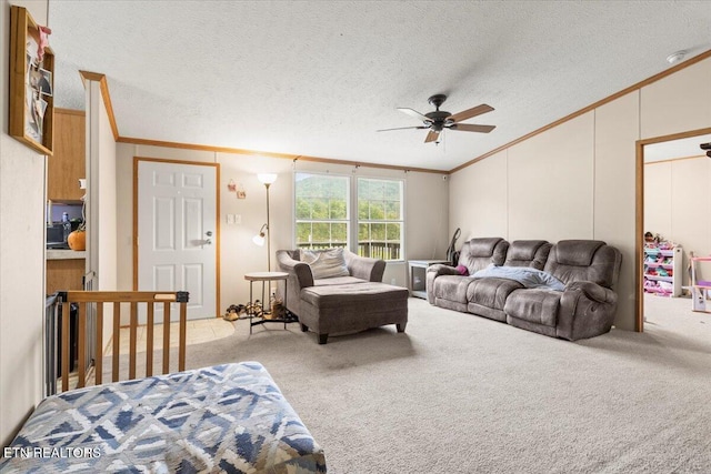 carpeted living room with ceiling fan, a textured ceiling, and crown molding