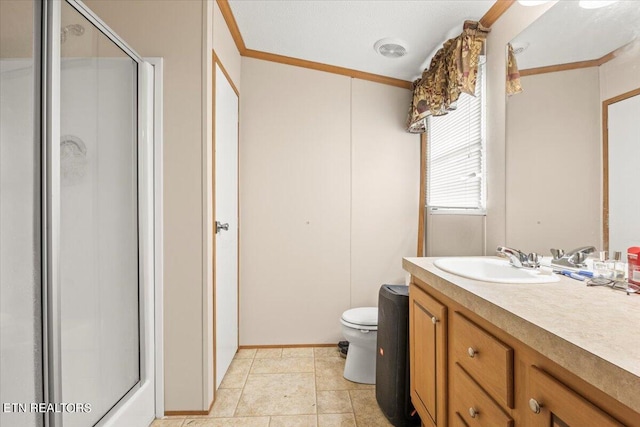 bathroom featuring crown molding, a shower with door, vanity, and toilet