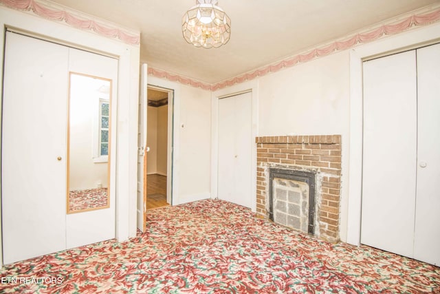 unfurnished living room with carpet floors and a brick fireplace