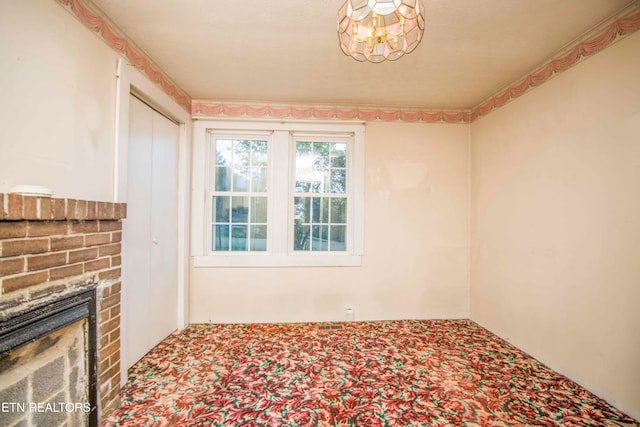 carpeted spare room with a fireplace