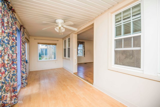 empty room with light hardwood / wood-style flooring and ceiling fan