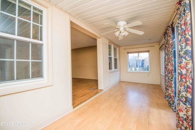 spare room with light wood-type flooring and ceiling fan