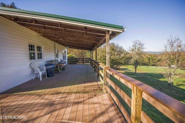 wooden terrace with a yard