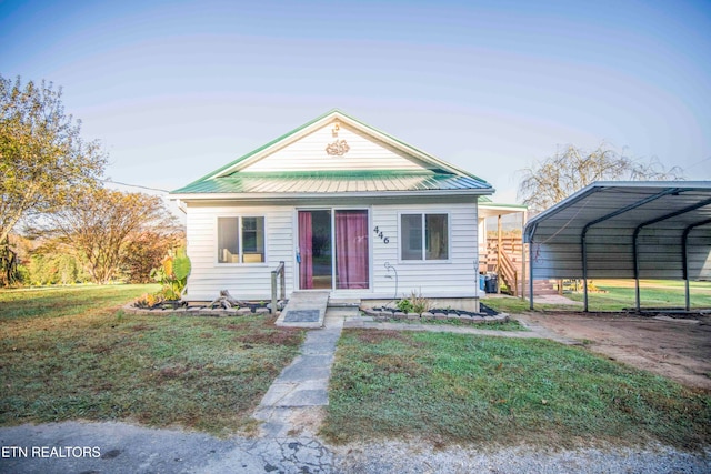 bungalow-style house with a carport and a front yard