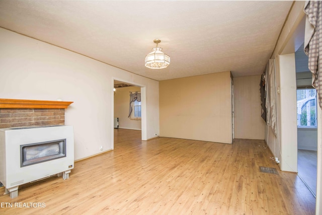 unfurnished living room featuring a fireplace and light wood-type flooring