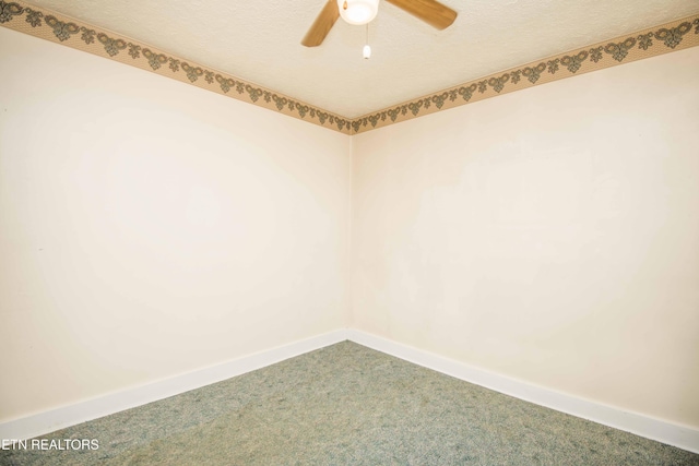 unfurnished room featuring baseboards, carpet, and a ceiling fan
