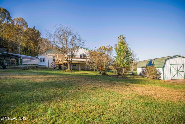 view of yard with a storage shed and a carport