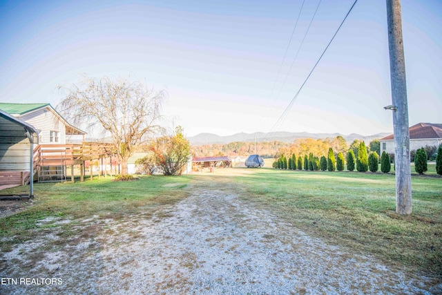 view of yard featuring a deck with mountain view