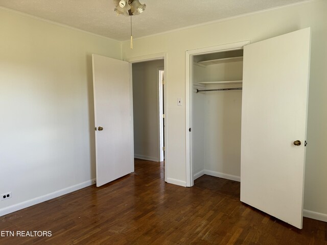 11806 Dry Valley Rd, Loudon, TN 37774 - unfurnished bedroom featuring dark wood-type flooring, a closet, baseboards, and crown molding