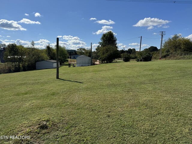 11806 Dry Valley Rd, Loudon, TN 37774 - view of green lawn with a storage unit and an outdoor structure