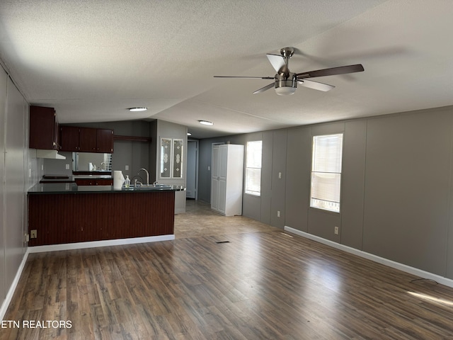 11806 Dry Valley Rd, Loudon, TN 37774 - kitchen featuring dark countertops, ceiling fan, open floor plan, a peninsula, and wood finished floors