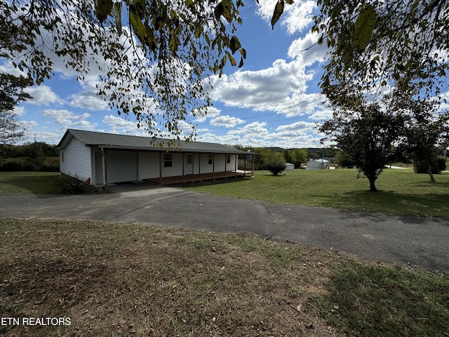11806 Dry Valley Rd, Loudon, TN 37774 - view of front of home with asphalt driveway, a front yard, covered porch, metal roof, and an attached carport