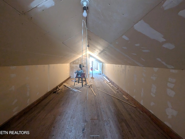 bonus room with hardwood / wood-style flooring and lofted ceiling