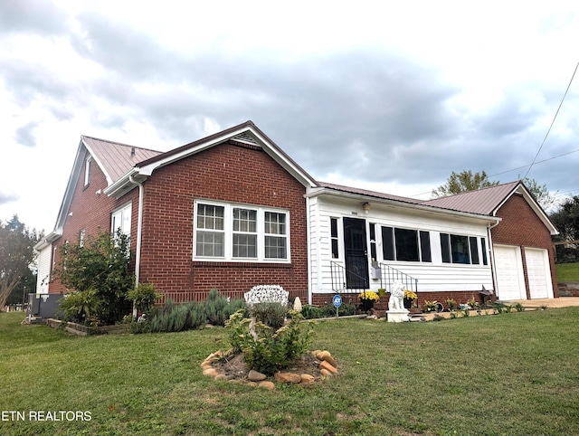 1005 Monroe St, Sweetwater, TN 37874 - view of front of home with a garage, brick siding, a front yard, and metal roof