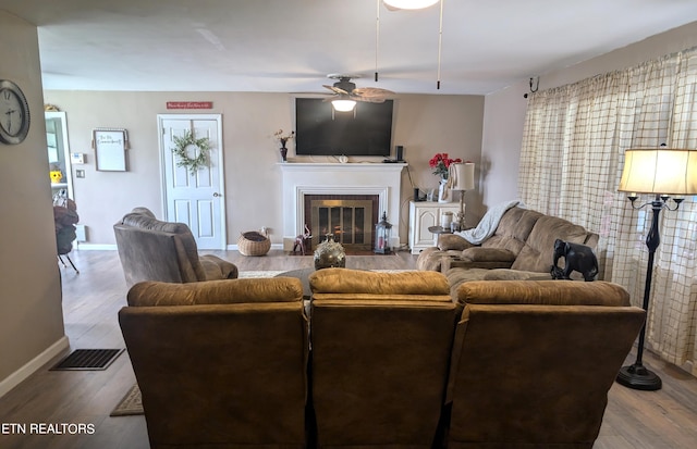 living room with light hardwood / wood-style flooring and ceiling fan