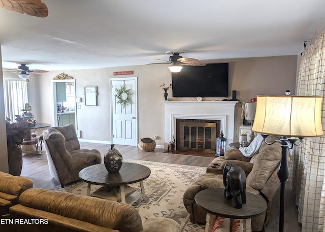 1005 Monroe St, Sweetwater, TN 37874 - living room featuring a fireplace with flush hearth, baseboards, wood finished floors, and ceiling fan