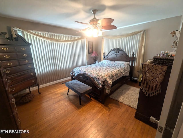 bedroom with ceiling fan and hardwood / wood-style flooring