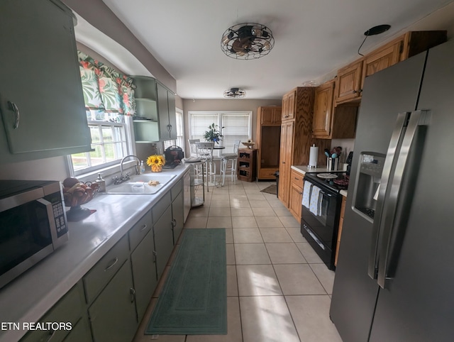 1005 Monroe St, Sweetwater, TN 37874 - kitchen featuring stainless steel appliances, a sink, light tile patterned flooring, open shelves, and light countertops