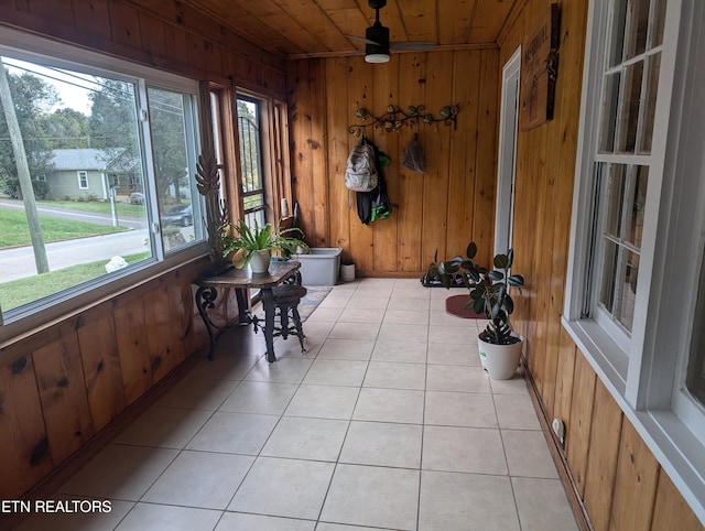 sunroom / solarium featuring ceiling fan and wood ceiling