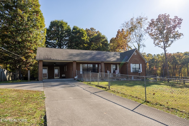 view of front facade with a front yard and a carport