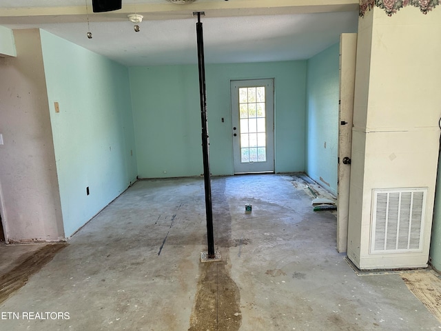 empty room with concrete flooring