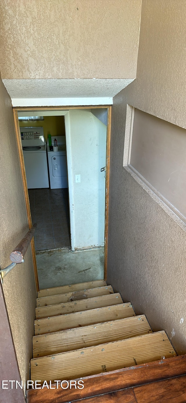 stairs featuring washer and dryer