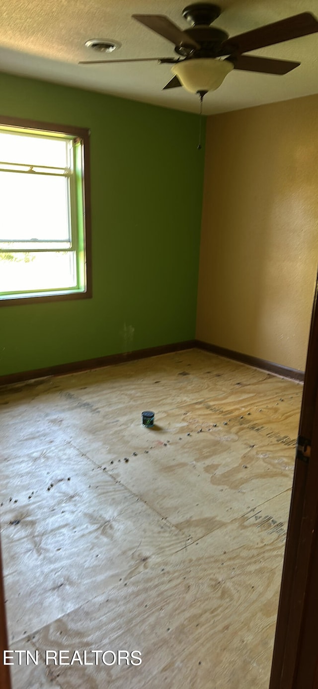 spare room with ceiling fan