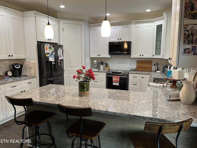 kitchen with a peninsula, tasteful backsplash, white cabinetry, black refrigerator with ice dispenser, and stainless steel range with electric stovetop