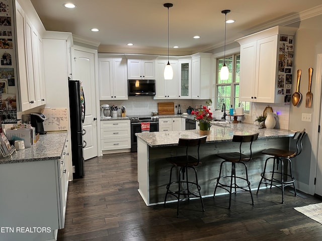 kitchen with kitchen peninsula, white cabinetry, stainless steel appliances, and pendant lighting