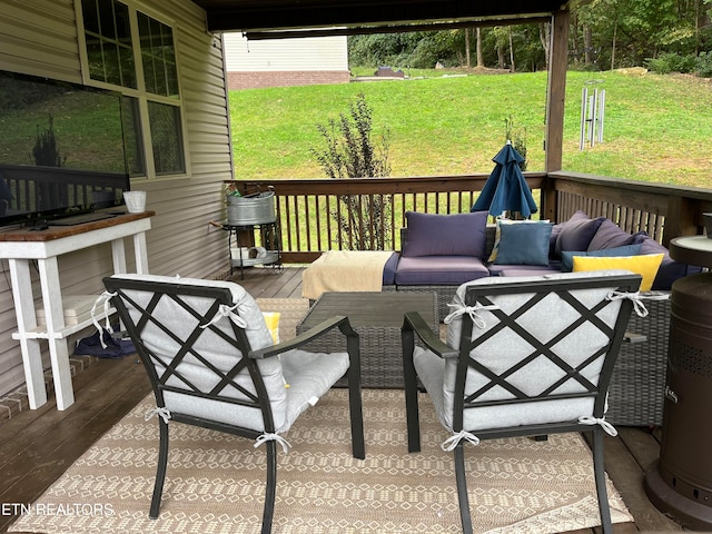 wooden deck featuring a yard and an outdoor living space