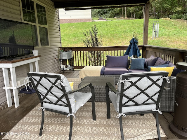 wooden deck featuring a lawn and an outdoor hangout area