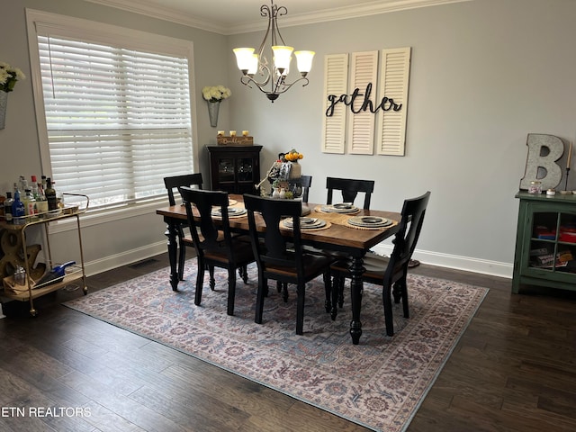 dining area with ornamental molding, an inviting chandelier, and dark hardwood / wood-style flooring