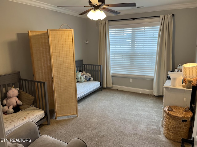 carpeted bedroom featuring crown molding and ceiling fan