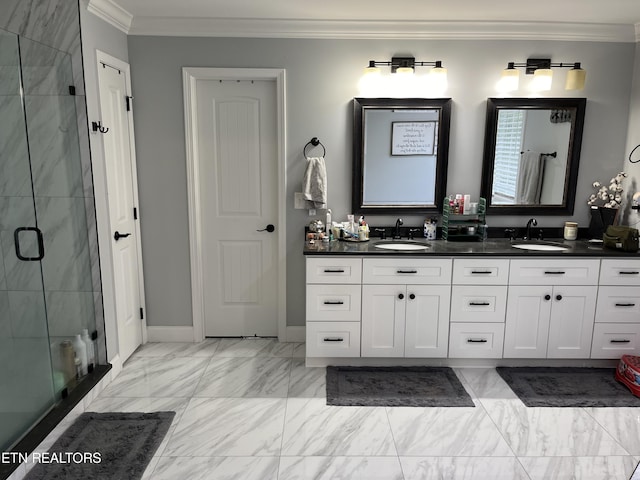 bathroom featuring a sink, a shower stall, double vanity, and crown molding