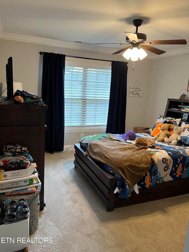 carpeted bedroom featuring ceiling fan and ornamental molding